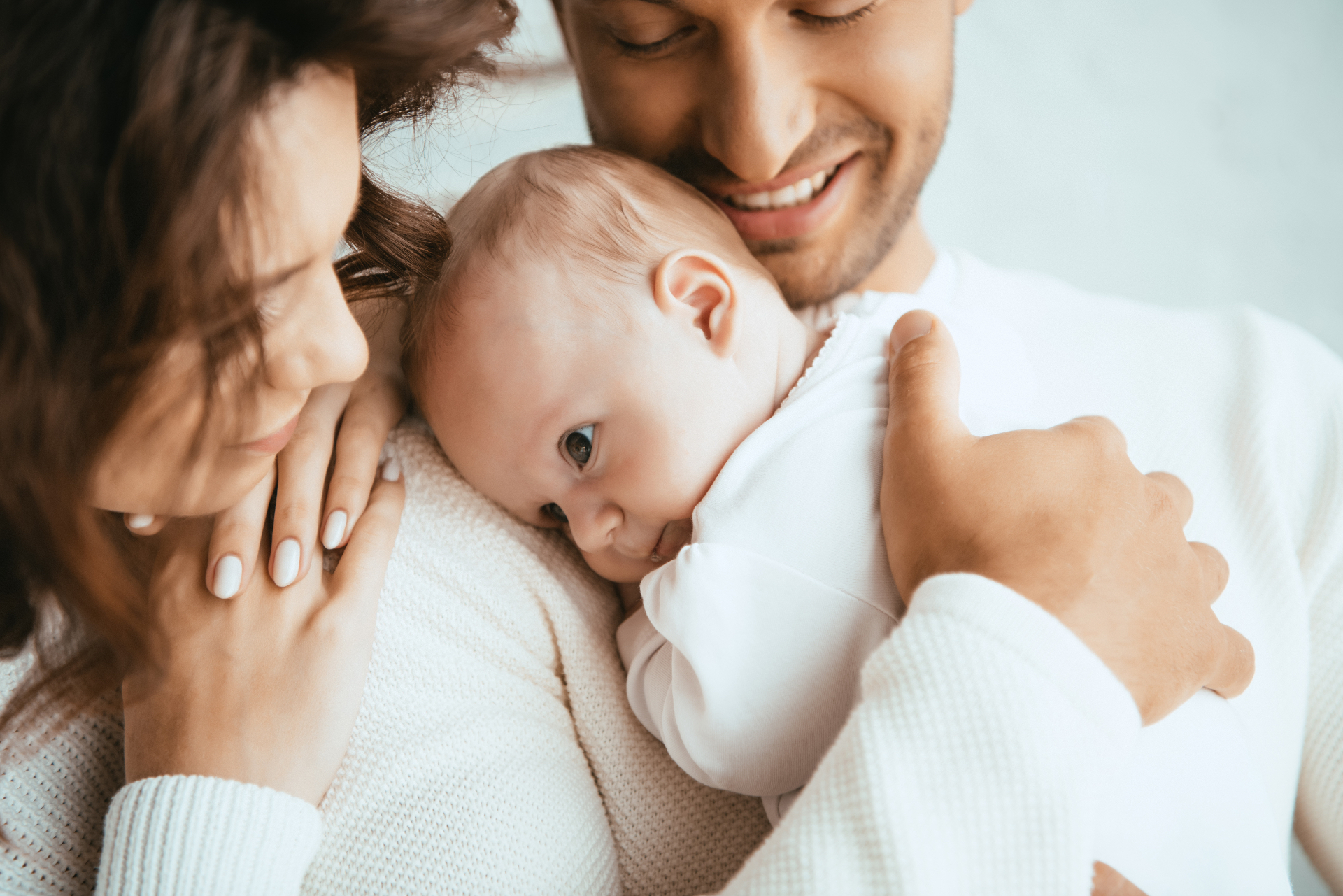 Parents cuddling their newborn